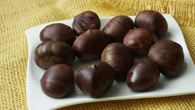 Ripe chestnuts close up. Fresh sweet chestnut. Raw Chestnuts for Christmas.