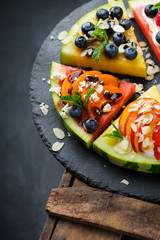 Watermelon pizza with berries, fruits, yogurt, feta cheese