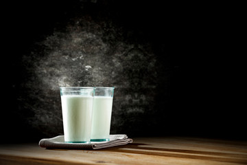 Fresh milk on desk and black space 