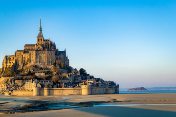 Fototapeta na wymiar Mont Saint Michel. a small rocky island turned into an island fortress on the northwest coast of France. This natural and historical complex is one of the most famous tourist sites. 