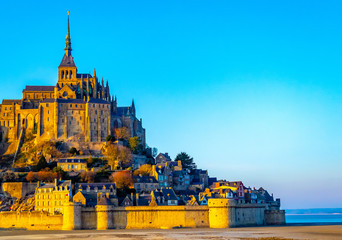 Fototapeta na wymiar Mont Saint Michel. a small rocky island turned into an island fortress on the northwest coast of France. This natural and historical complex is one of the most famous tourist sites. 