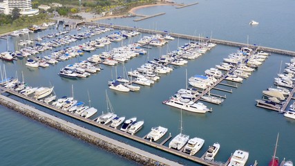 Aerial View by Drone of Yacht Club and Marina. Top view of yacht club. White boats in sea water....