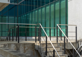 Iron railing with concrete building.