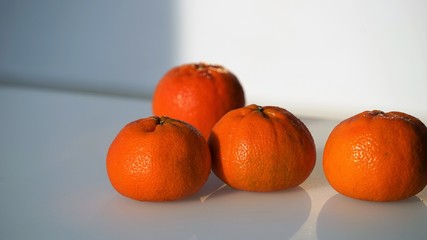 Close up view on whole tangerines by blurred background
