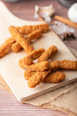 Hot and spicy Korean barbeque fried chicken on wood cutting board
