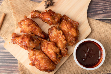Hot and spicy Korean barbeque fried chicken on wood cutting board