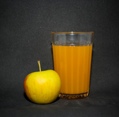 Citrus juice next to Apple