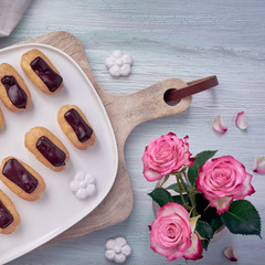 Mini vanilla eclairs with chocolate frosting, top view