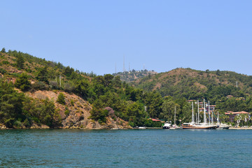 Naklejka premium June 17, 2019 Fethiye Turkey, - View from the ship on the coastal mountains covered with forest