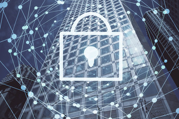 Lock icon hologram on city view with skyscrapers background multi exposure. Data security concept.