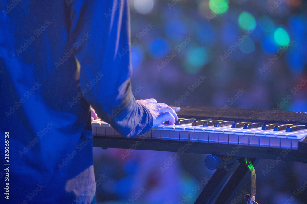 Poster A musician playing keyboard in live concert,A keyboard instrument is a musical instrument played using a keyboard, a row of levers which are pressed by the fingers.