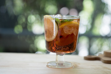 Close up of glass with beautiful refreshing lime slice and peach