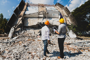 Demolition control supervisor and contractor discussing on demolish building.