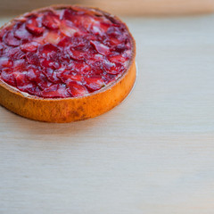 Classic cheesecake with strawberry slices in jelly on top.