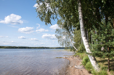 Summer view of the lake Hallanlahti  with reflection of clouds on the surface of the water . Finland .