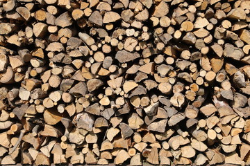 background of many wooden logs in the woodshed