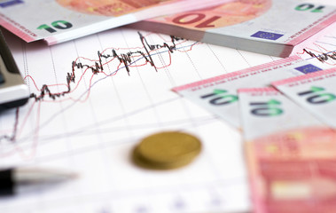 European Retail prices graphics. euro bills on the graph. Pen,calculator near heap of euro coins. Concept of retail trading