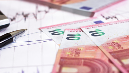 European Retail prices graphics. euro bills on the graph. Pen,calculator near heap of euro coins. Concept of retail trading