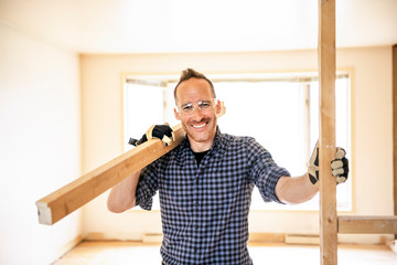 A man worker in the carpenter workroom renovation wolding wood