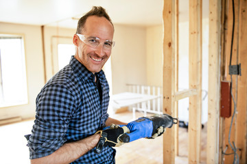 A man worker in the carpenter workroom renovation