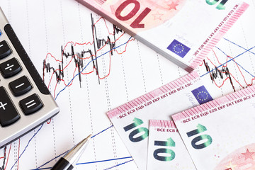 European Retail prices graphics. euro bills on the graph. Pen,calculator near heap of euro coins. Concept of retail trading