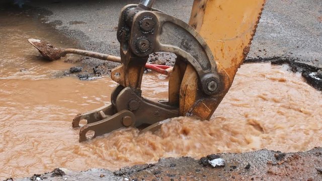 Repair the broken pipe for domestic water on the mud ground.