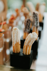 churro bar at wedding reception, churros at event, close up, dipped