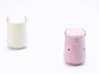 Fresh blueberry yogurt glass on a white background