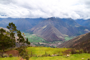 View of Sacred Valley landscape in the Cusco region in Peru on a cloudy day with clouds over the mountain tops