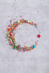 Sweet Islam symbol - star and crescent made of colorful sprinkles. Top view