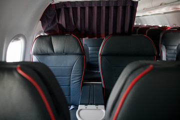Airplane cabin seats with passengers. Economy class of new cheapest low-cost airlines without delay or cancellation of flight.