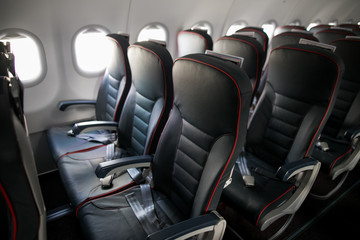 Airplane cabin seats with passengers. Economy class of new cheapest low-cost airlines without delay or cancellation of flight.