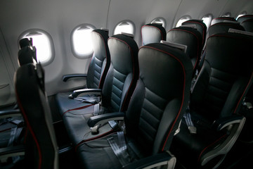 Airplane cabin seats with passengers. Economy class of new cheapest low-cost airlines without delay or cancellation of flight.