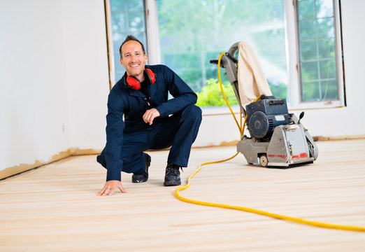 A Sanding Hardwood Floor With The Grinding Machine.