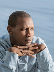 Portrait of a handsome pensive man looking at the sunrise