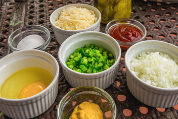 Fresh Ingredients in Ramequins on a Brown Picnic Table