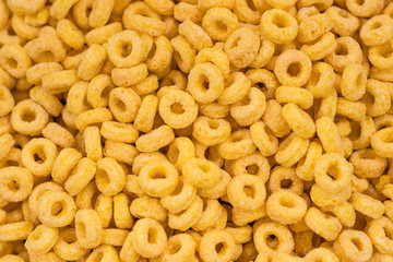 Ringlets corn flakes or chips, background, texture. Morning breakfast concept.