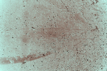 Vintage cyan background. Rough painted wall of hazel color. Imperfect plane of brown colored. Uneven old decorative toned backdrop of blue tint. Texture of azure hue. Ornamental stony surface.