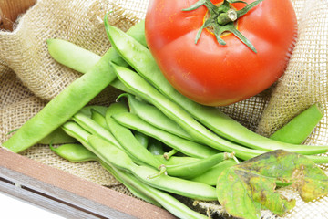 green beans and tomatoes on background