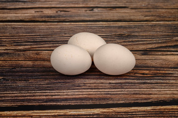 Chicken egg on wooden table background. close up