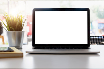 Blank screen Laptop computer and poster workspace background in modern office.