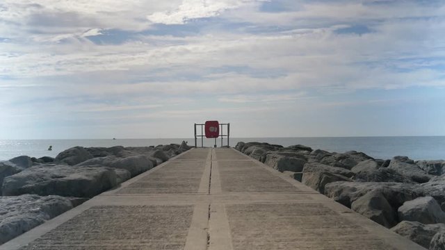 Stone jetty pier heading for water in Croyde England. Sea View wide shot.