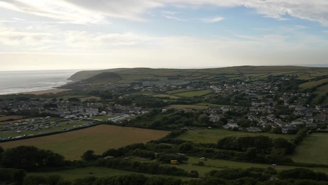 Croyde Coastal Town in UK. Panning aerial shot of the city, the beach and the sea