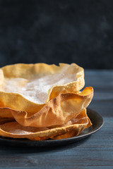 Close up Papadum or papad traditional indian food, vegetarian bread from lentils or beans. Food popular in Nepalese, Pakistani, Indian and Bangladeshi cuisines. Space for text.