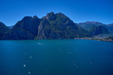 Aerial view of Lake Garda, mountains, cliffs and the city of Riva del Garda, Italy.