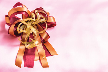 red gift box with ribbon and bow isolated on pink background