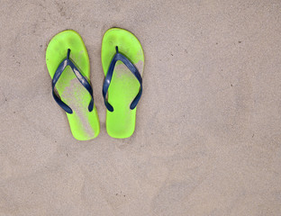 flip flops on the sand beach of the sea during summer vacations