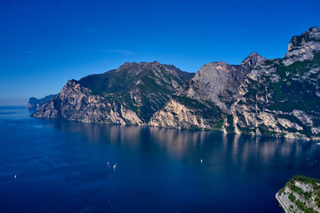 Aerial view of Lake Garda, mountains, cliffs and the city of Riva del Garda, Italy.