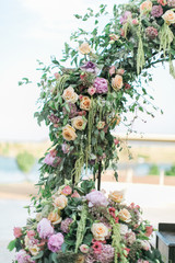 Wedding arch decorated with pink flowers, ornate bohemian wedding