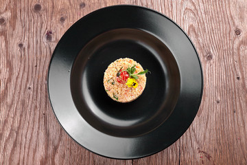 Couscous on a black plate